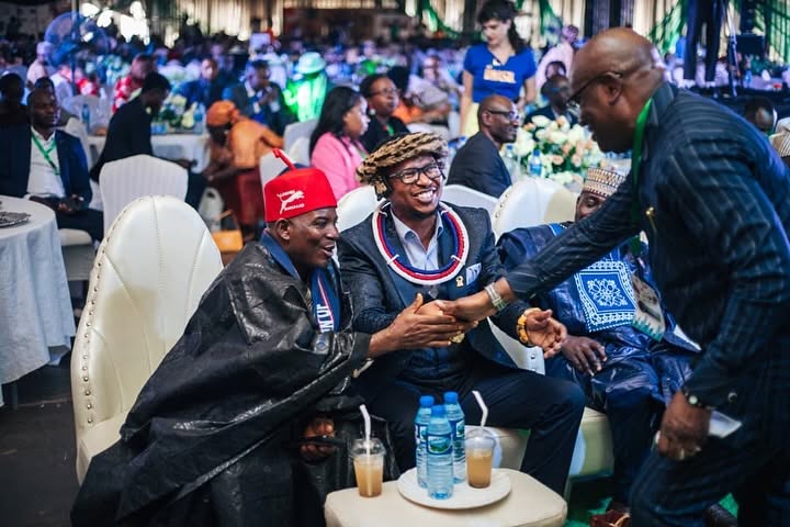 Festival guests greet each other among the audience